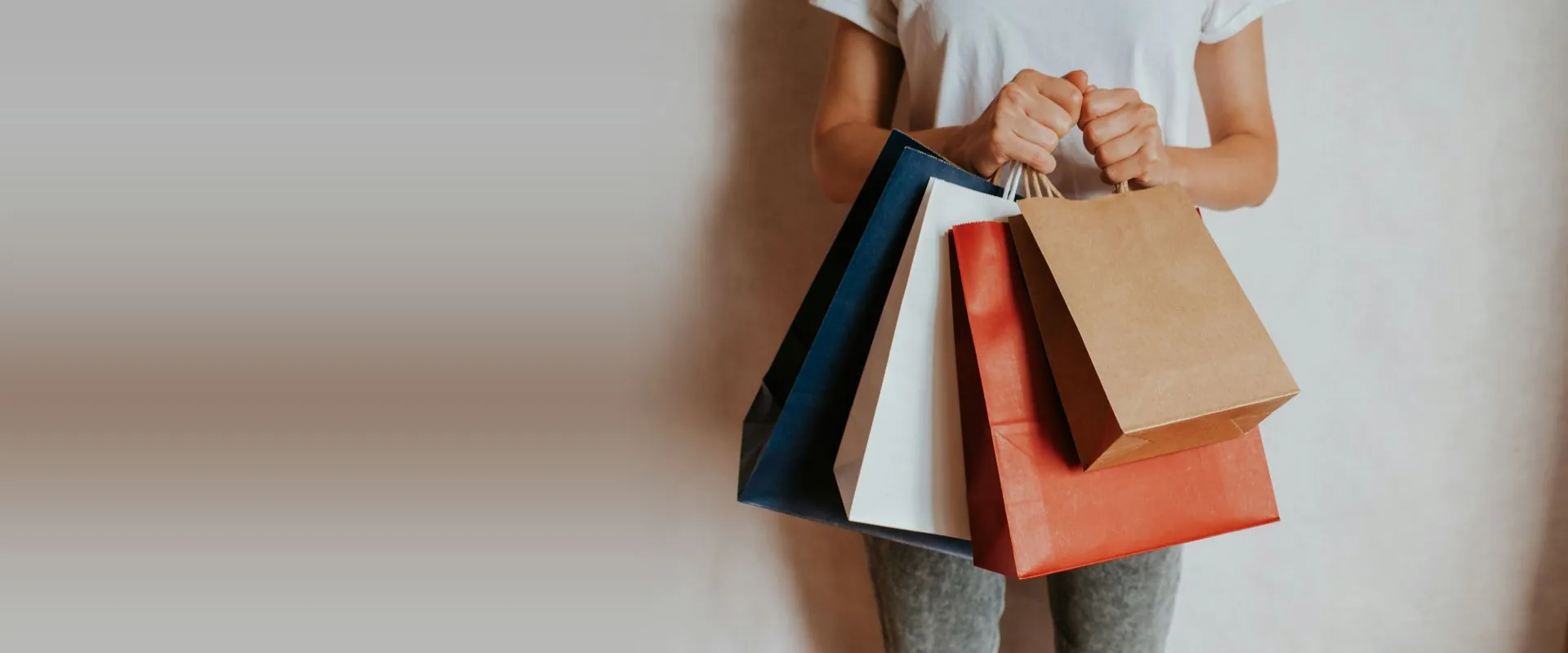 Shopper holding colourful shopping bags